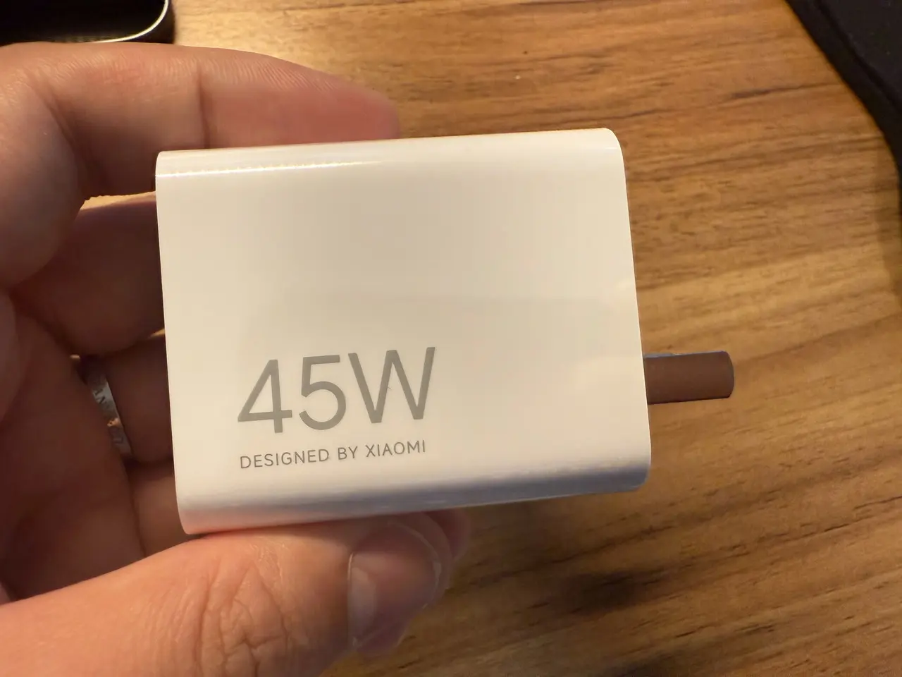 Xiaomi Pad 8の電源アダプタを手に持っている様子