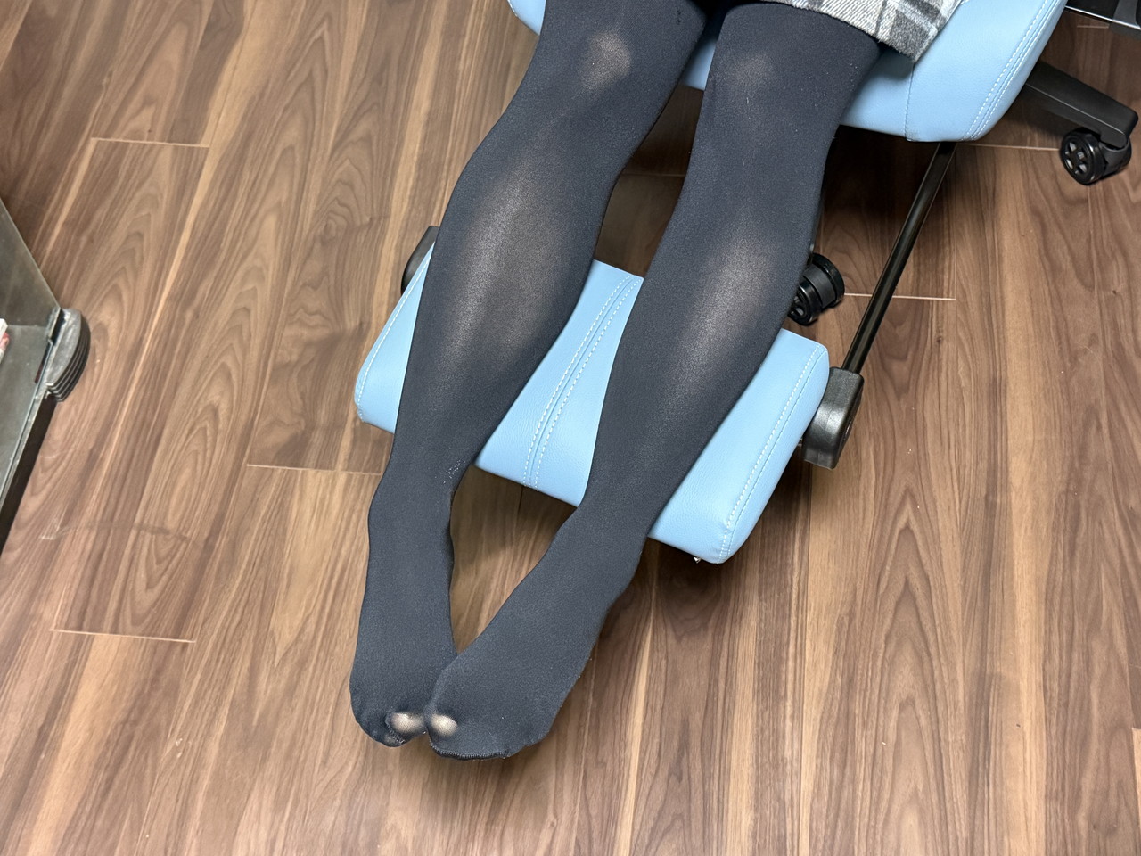収納式オットマンに脚を載せている様子