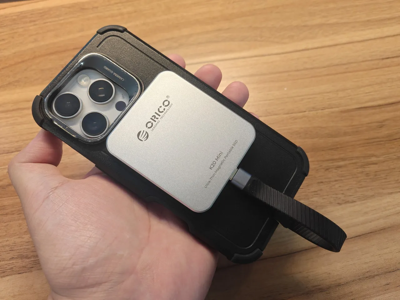 ORICO K20 Miniを装着したiPhoneを手に持っている